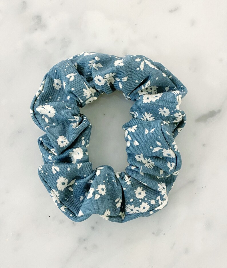 May include: A blue and white floral patterned scrunchie.