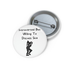 May include: White button with black text that reads "Introverted But Willing To Discuss Ska". A black silhouette of a person dancing ska is below the text.