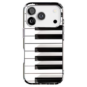 May include: A smartphone case featuring a piano keyboard design. The case has a clear border and a white top section with three camera lenses. The keyboard design alternates black and white keys, creating a musical theme.