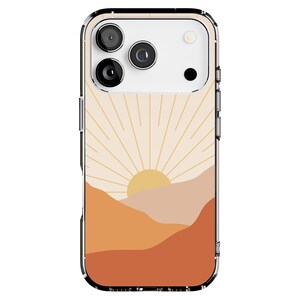 May include: Clear phone case with a sunset design. The case features a vibrant illustration of a sun setting over layered mountains in shades of orange, peach, and beige. The phone's camera lenses are visible at the top.