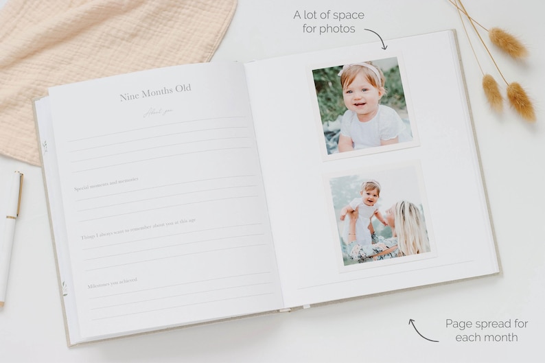May include: An open baby memory book with a page titled Nine Months Old featuring lined sections for notes and milestones. The right page displays two square photographs of a child, with text annotations indicating space for photos and a page spread.