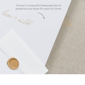 May include: A white box containing a beige linen-covered book and a white envelope sealed with a gold wax stamp featuring a botanical design. The box lid displays the text "love + wild" and "Arrives in a beautiful keepsake box to preserve your book for years to come" with an arrow.