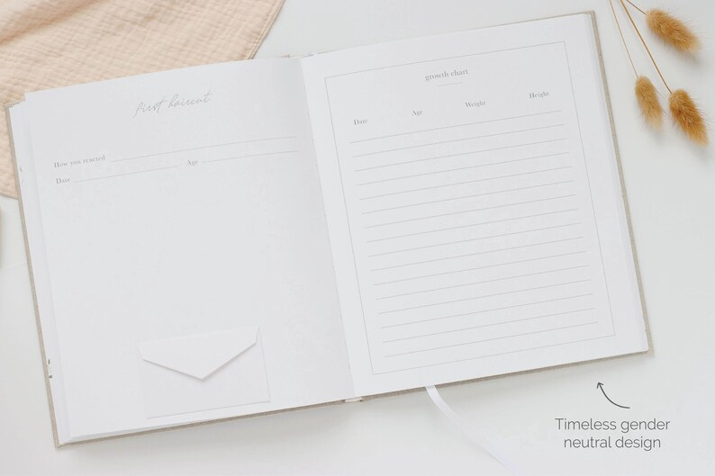 May include: An open memory book with light beige covers featuring two pages. The left page is titled First Discoveries with fields for date and age. The right page is titled Growth Chart with columns for date, age, weight, and height. A small white envelope is attached to the left page.