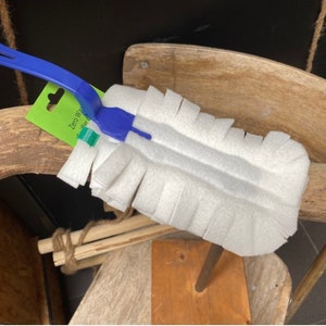May include: A white microfiber duster with a blue plastic handle. The duster is attached to a wooden dowel. The packaging says "Zero Waste Duster for Cleaning".