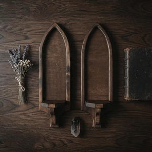 Pair of gothic wall sconces styled with dried lavender, crystal, and antique book