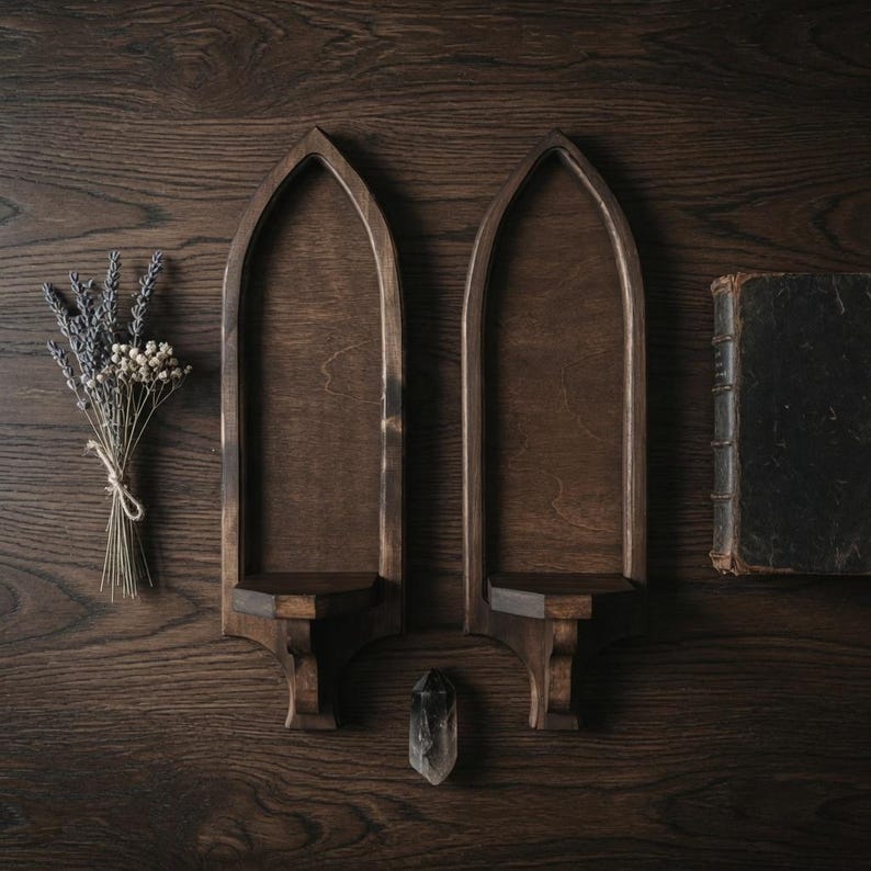 Pair of gothic wall sconces styled with dried lavender, crystal, and antique book