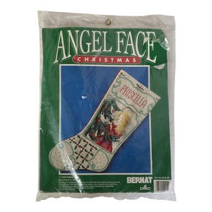 May include: A cross-stitch kit for a Christmas stocking featuring an angel with a Christmas tree and the name "Priscilla". The kit is by Bernat and includes DMC floss.