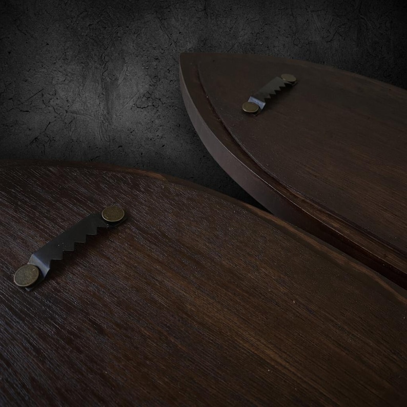Close-up of dark walnut sconce backs showing sawtooth hanger mounting hardware
