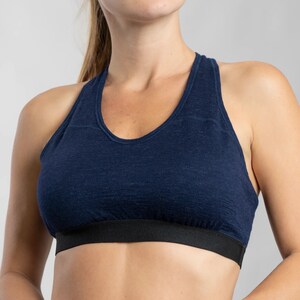 K&ouml;nnte beinhalten: Ein marineblauer Sport-BH mit Racerback-Design und einem schwarzen elastischen Band am unteren Rand.