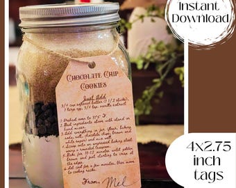 May include: A mason jar filled with dry ingredients for chocolate chip cookies. A brown tag with white text is attached to the jar with the recipe for the cookies. The tag reads "Chocolate Chip Cookies" and includes instructions for baking the cookies. The tag is signed "From, Mel". The text at the bottom of the image reads "4x2.75 inch tags".