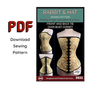 May include: A sewing pattern for a front and back tie over bust corset. The pattern is called "Rabbit & Hat" and is designed and printed in the U.S.A. The pattern includes a detailed illustration of the corset.
