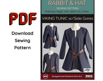 May include: A PDF sewing pattern for a Viking tunic with side gores. The pattern includes images of the tunic in navy blue, featuring a V-neck and a brown belt. The text "Rabbit & Hat" and "Sewing Pattern" are visible.