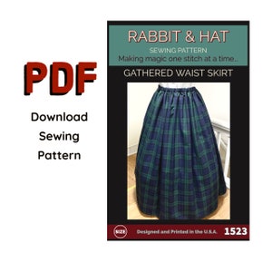 May include: PDF download for a sewing pattern for a gathered waist skirt. The pattern is called "Rabbit & Hat" and the skirt is a green and black plaid. The pattern number is 1523.