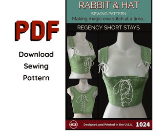 May include: A sewing pattern for a Regency short stays, also known as a corset, with a green and white polka dot fabric. The pattern is titled "Rabbit & Hat Sewing Pattern: Making magic one stitch at a time... Regency Short Stays" and includes the number "1024".