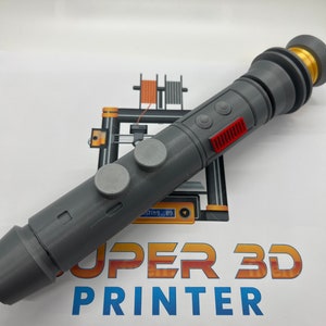 May include: A gray 3D printed lightsaber prop with a gold tip and red and gray buttons. The lightsaber is on a white surface with a 3D printer logo.