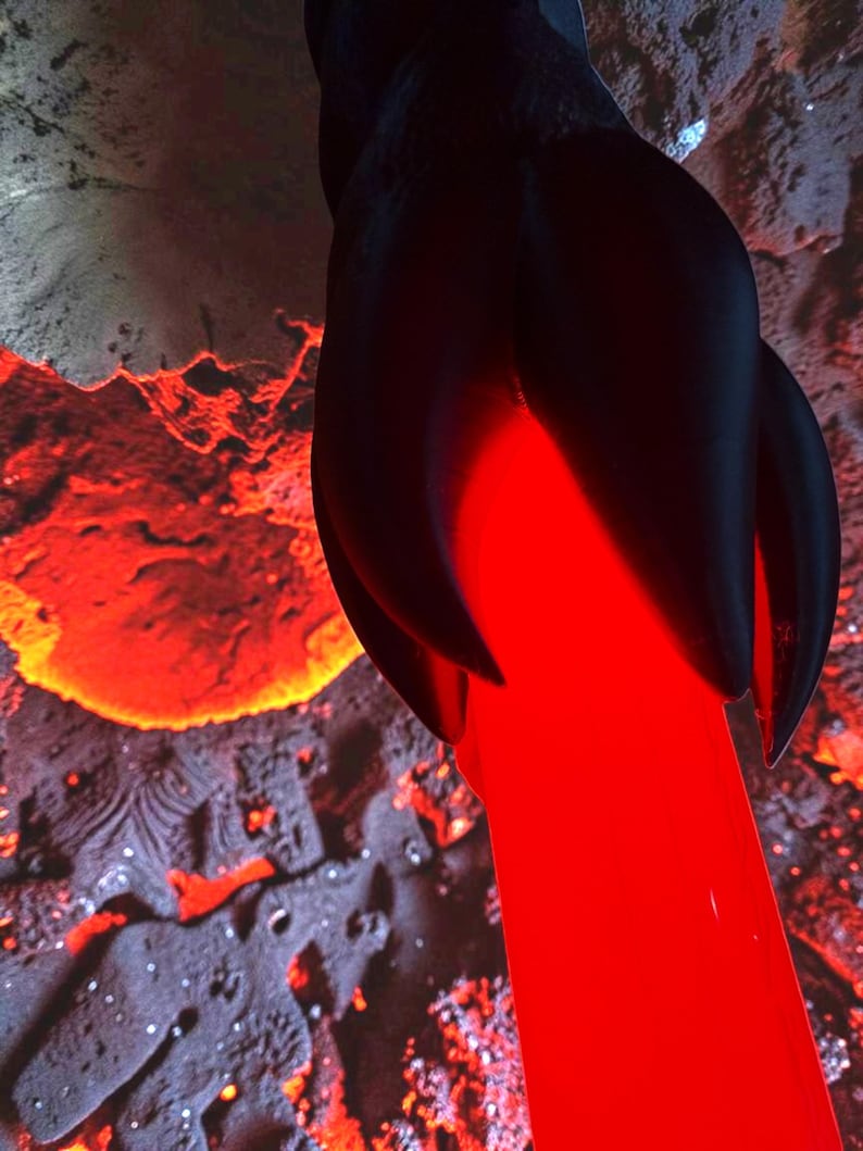 May include: A dark, abstract sculpture with a flowing, bright red element resembling lava. The sculpture has a textured, dark surface with a glowing red core. The background features a fiery, volcanic landscape.