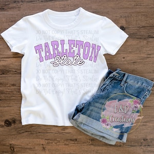 May include: A white t-shirt with the text "TARLETON State" in purple and white. The shirt is paired with denim shorts. The image also includes a watermark that says "D&D Creations".