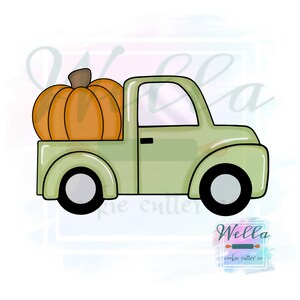 May include: A green pickup truck with a large orange pumpkin in the bed. The truck has black wheels and a white interior. The truck is a cookie cutter.
