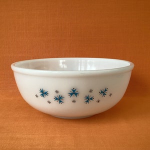 May include: White mixing bowl with a blue and black snowflake pattern.