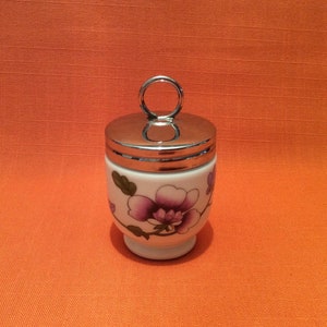 Royal Worcester Standard size ‘Astley’ Egg Coddlers, sold as one pair and one single, red and purple flowers, Royal Worcester Astley