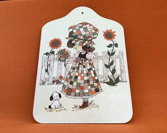 Holly Hobbie style chopping board in orange, brown and green colourway, retro kitchenware