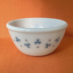 May include: White mixing bowl with a blue and black snowflake pattern.