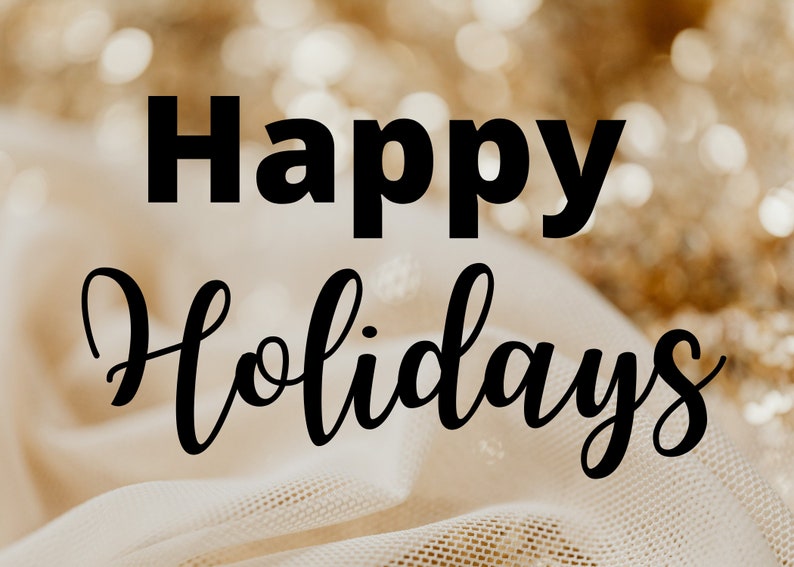 May include: Happy Holidays text in black lettering on a white fabric background with gold glitter out of focus.