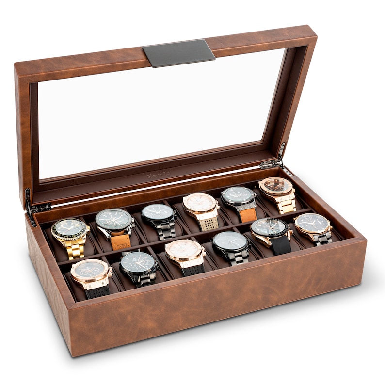 May include: A brown leather watch box with a glass top, open to reveal 15 watch slots. The box is filled with various wristwatches with different styles and colors.