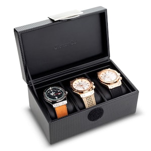 May include: A black watch box with a carbon fibre pattern and the text "Glenor Co" on the lid. The box contains three watches with different coloured straps.