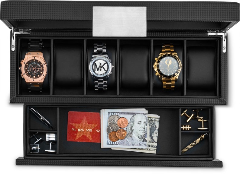 May include: Black leather watch box with a silver metal top. The box has two levels. The top level has five slots for watches. The bottom level has a slot for a credit card, a slot for cash, and a slot for cufflinks. The box is closed.