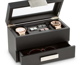 Könnte beinhalten: Schwarze Lederuhrenbox mit Glasdeckel und Schublade. Die Box hat ein silbernes Schild mit der Aufschrift "GlennCo.". Die Box enthält zwei Uhren, Manschettenknöpfe und eine Sonnenbrille.