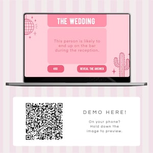May include: A pink and white laptop screen displaying a wedding game with the text "THE WEDDING" and "This person is likely to end up on the bar during the reception."  The screen also shows a button that says "REVEAL THE ANSWER". Below the laptop is a white card with a QR code and the text "DEMO HERE! On your phone? Hold down the image to preview."