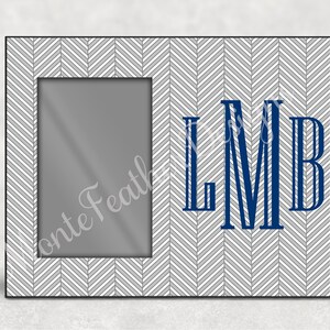 May include: A white and gray chevron patterned picture frame with a black border. The frame has a rectangular opening for a photo and the initials "LMB" in blue.