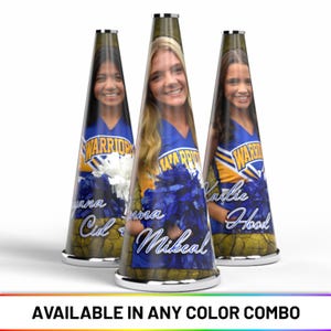 May include: Three personalized cheerleading megaphones. Each megaphone features a smiling person in a blue and gold uniform, with the word "WARRIOR" and a name. The megaphones have a silver base and top, with a textured background.
