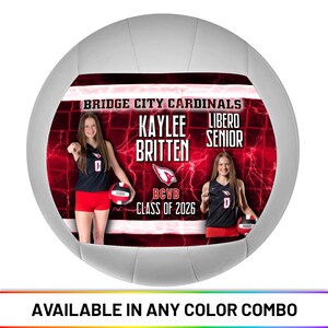 May include: A white volleyball with a red and black design featuring two young women. The design includes the text "BRIDGE CITY CARDINALS," player names, and "CLASS OF 2026." The bottom of the ball reads "AVAILABLE IN ANY COLOR COMBO."