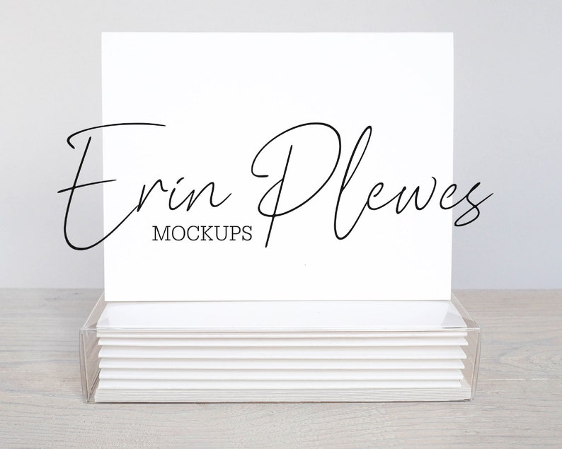May include: A stack of blank white note cards in a clear acrylic box. The top card has the text "Erin Plewes Mockups" written in black cursive.