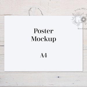 May include: A white poster mockup on a light wood background. The poster is A4 size and has the text "Poster Mockup" and "A4" printed on it.