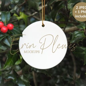 May include: White round ceramic bauble with a gold string hanging from a holly bush. The bauble has the text "Erin Plewes MOCKUPS" printed on it.