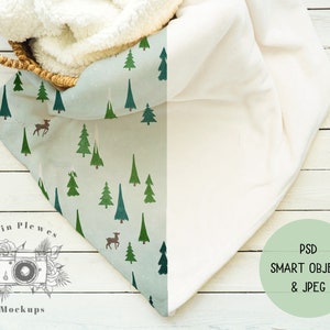 May include: A white faux fur throw blanket with a green and white patterned throw blanket underneath. The throw blankets are on a white wooden surface. The text "Erin Plewes Mockups" is printed on the surface. The text "PSD SMART OBJECT & JPEG" is printed on a green circle.