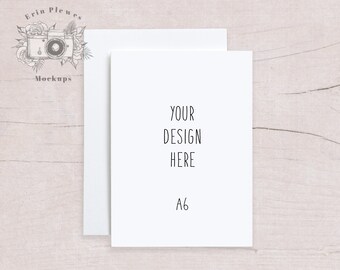 May include: A white card mockup on a light wood background. The card is blank with the text "YOUR DESIGN HERE" and "A6" written on it.