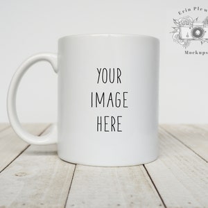 May include: White ceramic mug with a black inscription that reads "YOUR IMAGE HERE" on a white wooden surface.