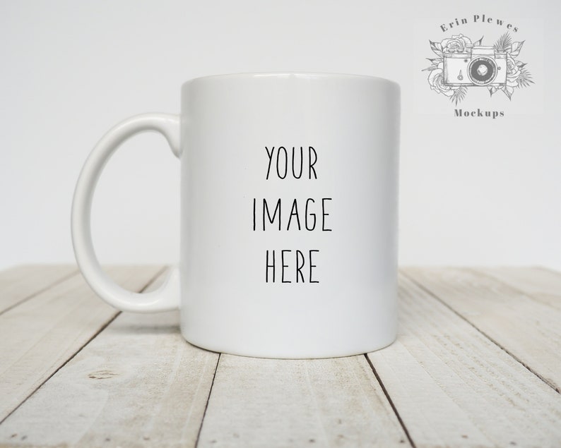 May include: White ceramic mug with a black inscription that reads "YOUR IMAGE HERE" on a white wooden surface.