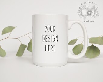 May include: White ceramic mug with a black handle. The mug has the text "YOUR DESIGN HERE" printed on the front.