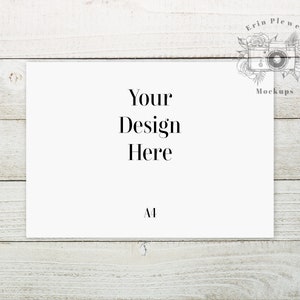 May include: A white card with the text "Your Design Here" and the letter "A1" printed on it. The card is sitting on a white wooden surface.