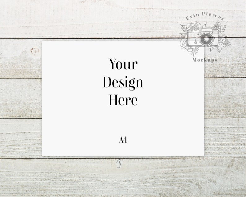 May include: A white card with the text "Your Design Here" and the letter "A1" printed on it. The card is sitting on a white wooden surface.
