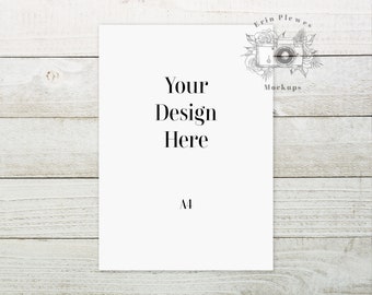 May include: A white A4 sheet of paper on a light wood background. The paper has the text "Your Design Here" and "A4" printed on it.