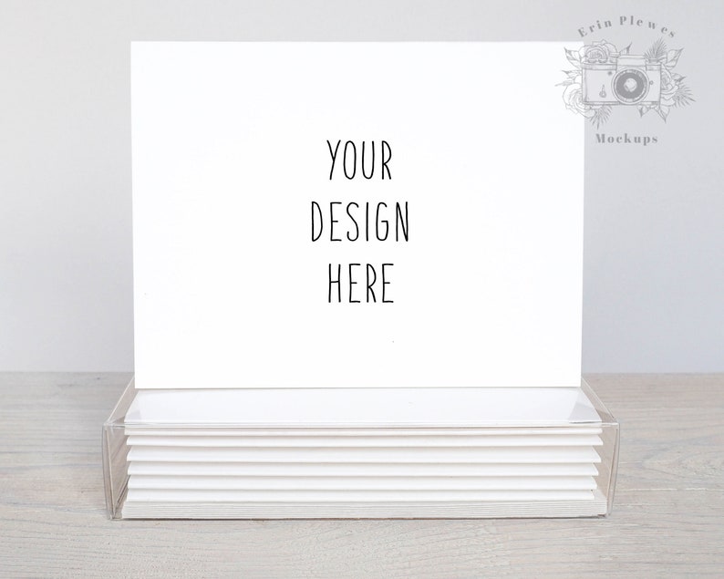 May include: A stack of blank white note cards in a clear plastic box. The top card has the text "YOUR DESIGN HERE" written on it.