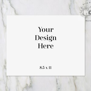 May include: A white card with the text "Your Design Here" and "8.5 x 11" printed on it. The card is lying flat on a white marble surface.