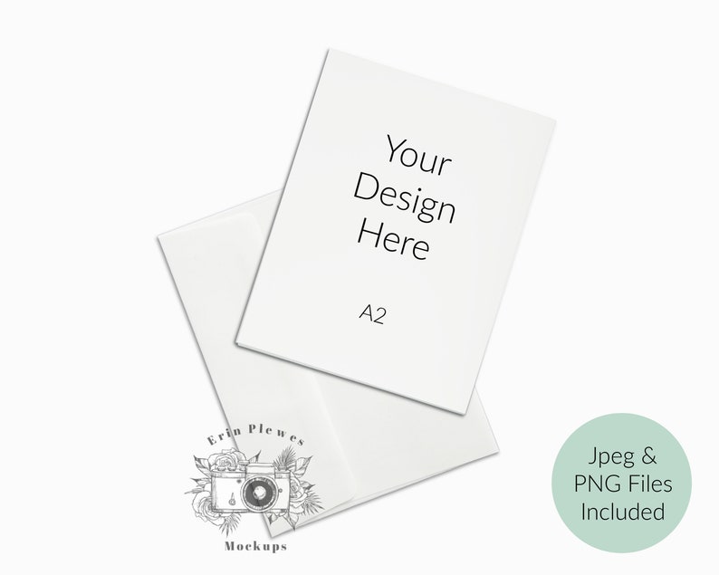 May include: A white A2 size paper mockup with the text "Your Design Here" on it. The paper is folded in half and is sitting on a white surface. The text "Jpeg & PNG Files Included" is written in a circle on the right side of the image.