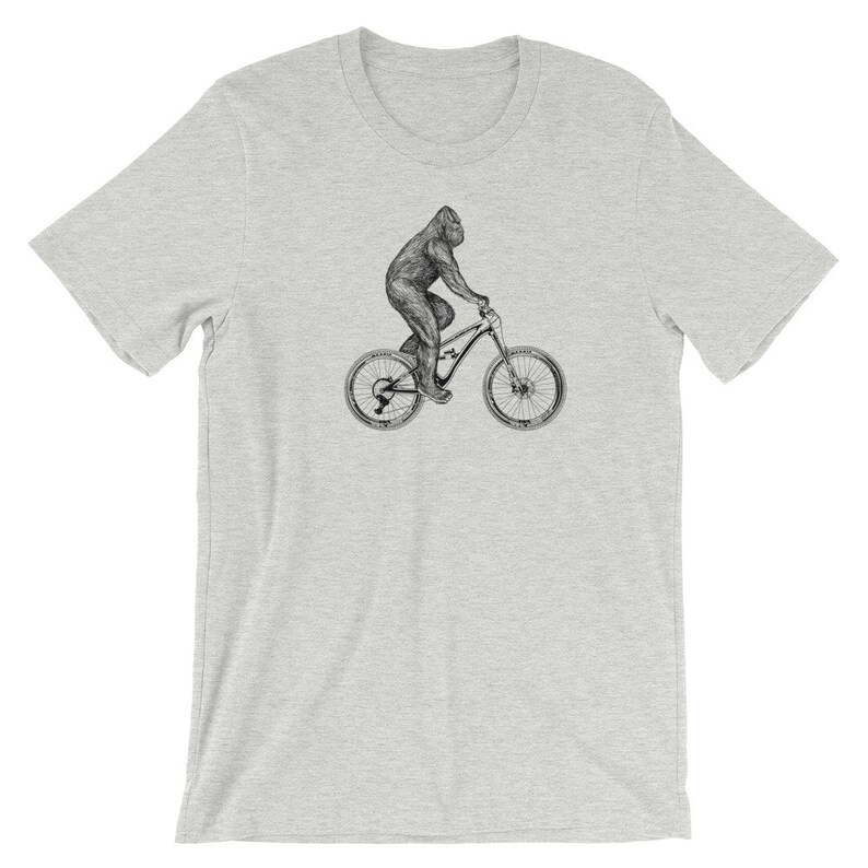 Puede incluir: Una camiseta gris con una ilustraci&oacute;n en blanco y negro de un gorila montando una bicicleta de monta&ntilde;a.